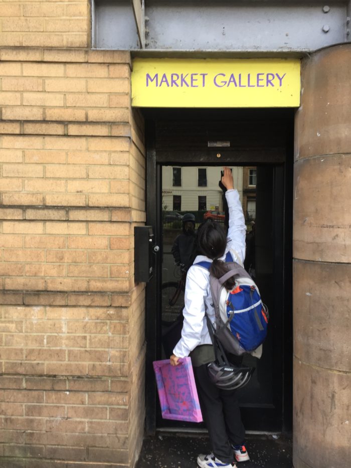 Ragini pulling the shutter for Market Gallery on Duke Street one last time